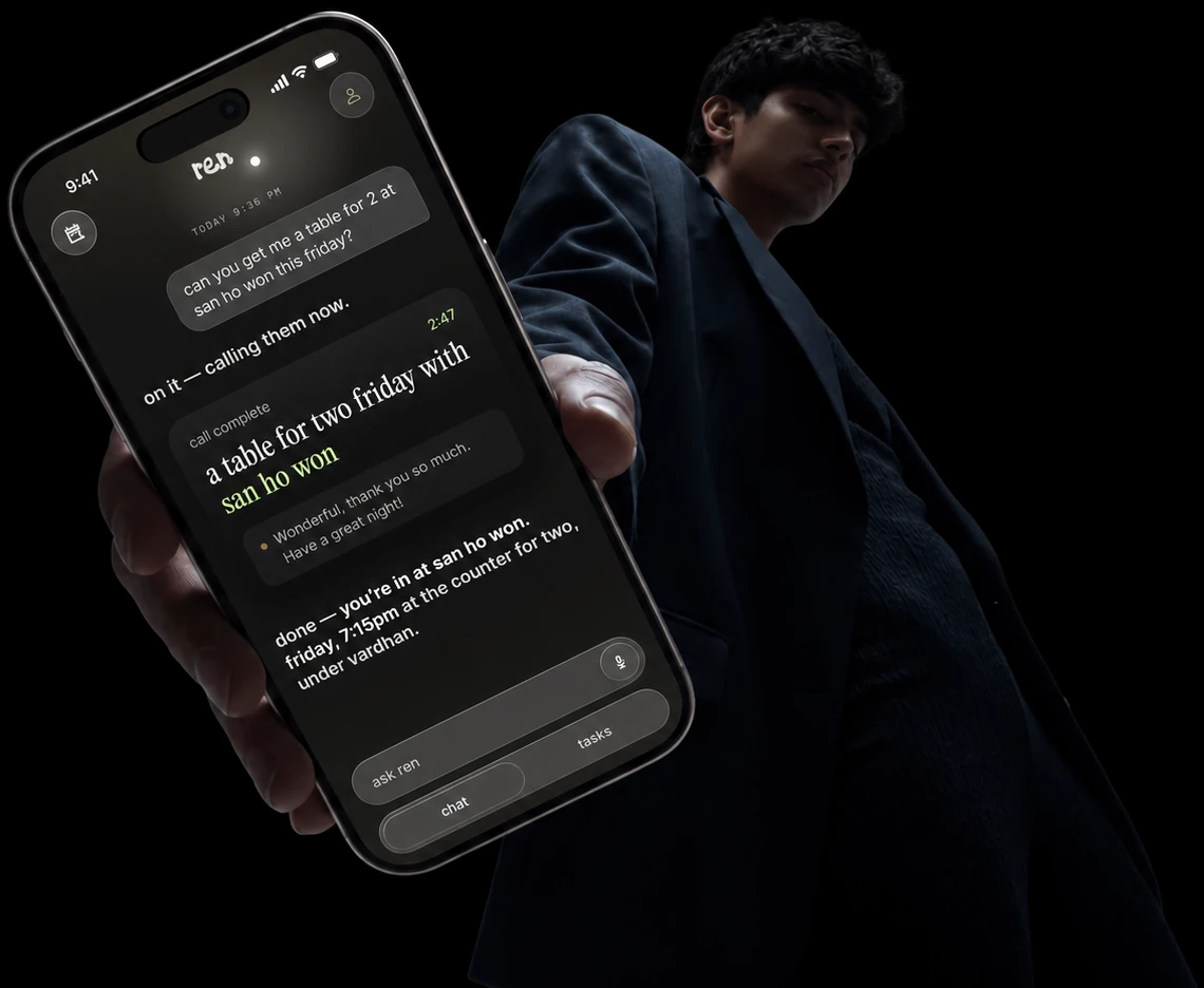 a hand holds out an iPhone running ren, which has just called san ho won and booked a table for two